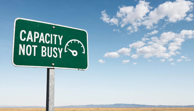 Capacity not busy road sign concept in open desert landscape under blue sky with clouds