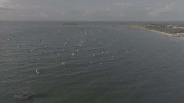 Aerial drone view of Mui Ne fishing village and Ganh Da Mui Ne coastline in Lam Dong, Vietnam, with fishing boats at sea, sandy beaches and a scenic coastal landscape.