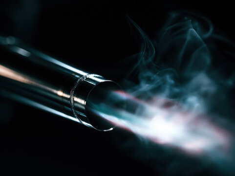Close-up of a Royal Enfield exhaust pipe with soft smoke, polished chrome, detailed welds, black background, cinematic lighting, ultra-realistic automotive advertisement
