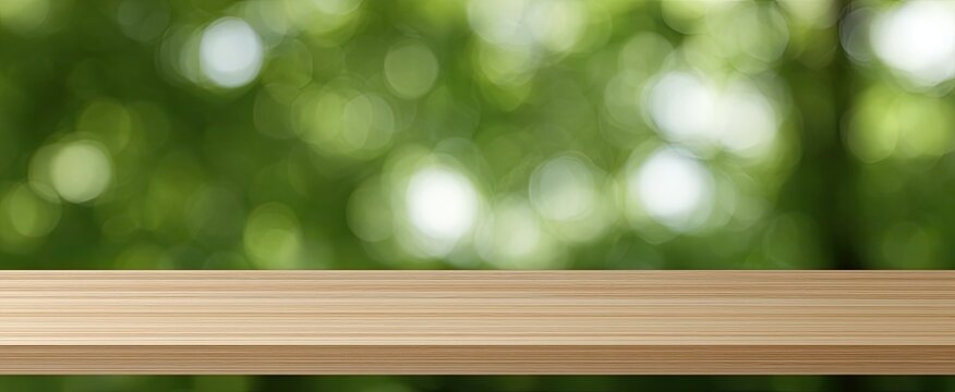 A wooden shelf in front of a soft green, blurred nature background