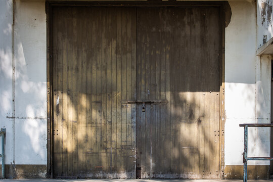 A large, old wooden door with a lock. Copy space background and texture
