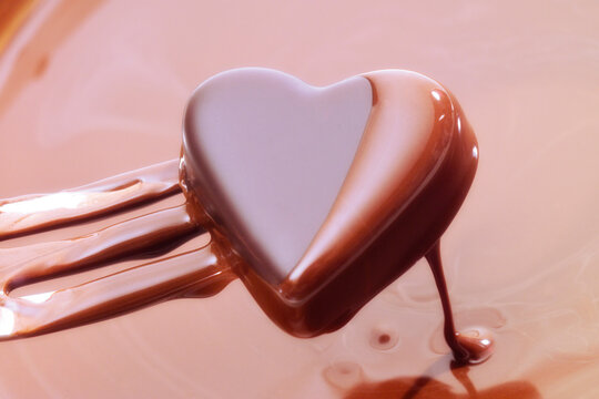 Chocolate heart dipped into chocolate sauce