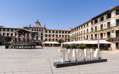 Naklejka premium Tudela, Spain - July 17, 2026: Plaza de los Fueros - Main square with uniform baroque architecture in Tudela, Navarre, Spain