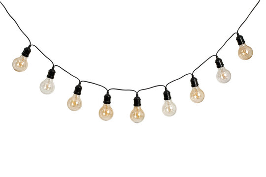 A string of hanging edison style light bulbs with glowing filaments arranged in a festive curved line isolated on a transparent background