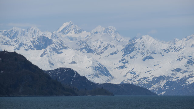 Breathtaking Alaska mountain glacier range view seen from outdoor deck of cruise ship liner sailing the Inside Passage transit with spectacular landscape wilderness scenery