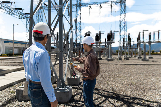Technicians measure electricity at a substation in Loja Ecuador