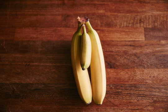 Bunch of two large and one small bananas