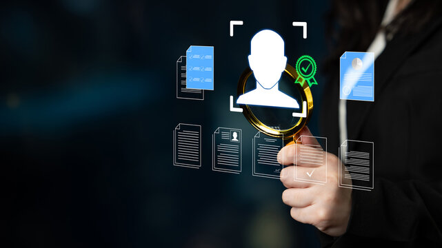 Person holding magnifying glass analyzing digital profile data with documents on a dark background showcasing concepts of identity verification and assessment Haptic.