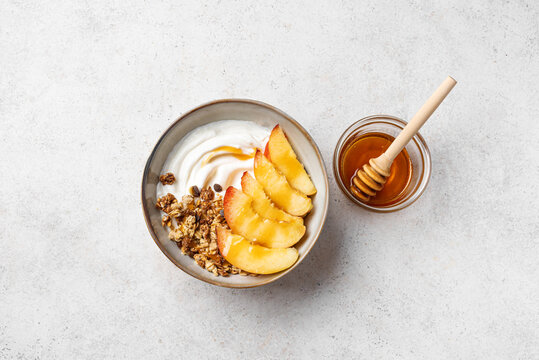 Granola bowl with yogurt, peach, and honey