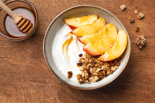 Granola bowl with yogurt, peach, and honey