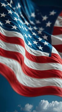 Close up of the united states flag waving against a clear blue sky on a sunny day