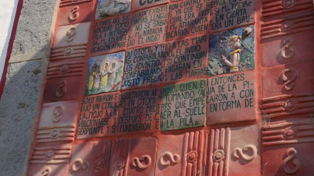 Pila de las Culebras ceramic tile plaque depicting local folklore in the historic center of Tapalpa Pueblo M&aacute;gico, Jalisco, Mexico. Cultural landmark tilt down shot.