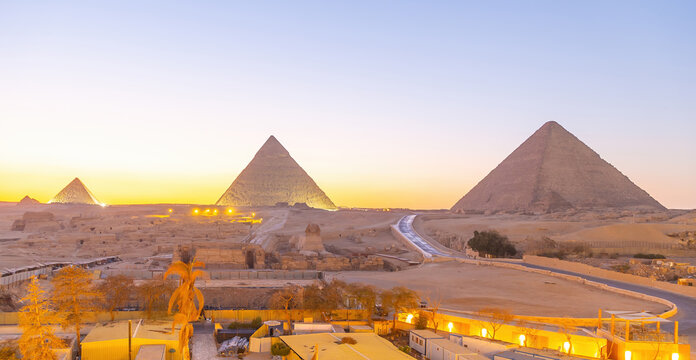 Great Sphinx and Pyramid of Khafre at dusk under artificial spotlighting on the Giza plateau