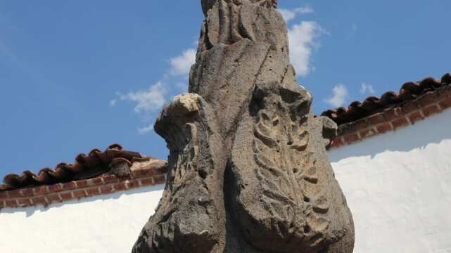 Pila de las Culebras carved stone fountain with multiple water spouts and decorative reliefs in Tapalpa Pueblo M&aacute;gico, Jalisco, Mexico. Tilt down detail shot.