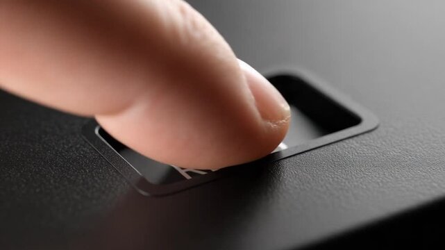 Close-up on a black 'RESET' button on a textured surface, symbolizing new beginnings.