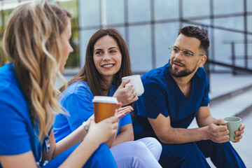 Medical Team Taking Coffee Break Together Outside Hospital During Casual Conversation