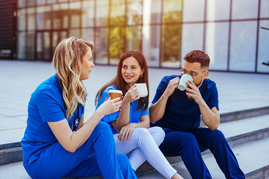 Healthcare Workers Taking a Coffee Break Outside Hospital Smiling Medical Staff Team