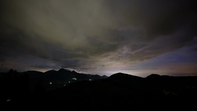 Night Timelapse of Cloudy Sky and Mountain Silhouettes with Stars