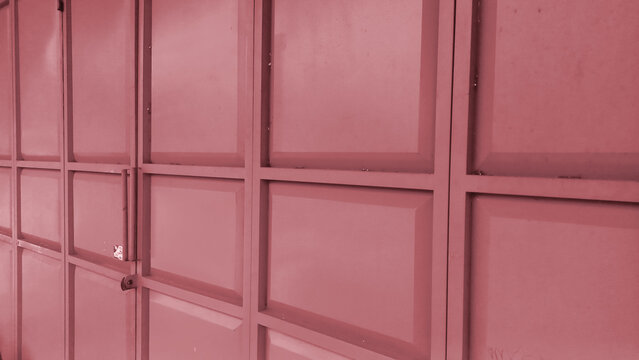 Background of a metal folding gate with pink panels.