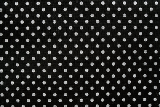 Black fabric pattern featuring white polka dots texture