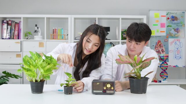 Teenage Students Conducting Plant Science Experiment in School Laboratory