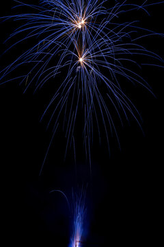 Blue Fireworks Burst and Sparkles on Dark Night Sky Background