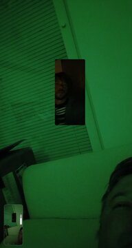 Abstract cyberpunk background with screen-in-screen recursion effect and a face silhouette in green ambient light.