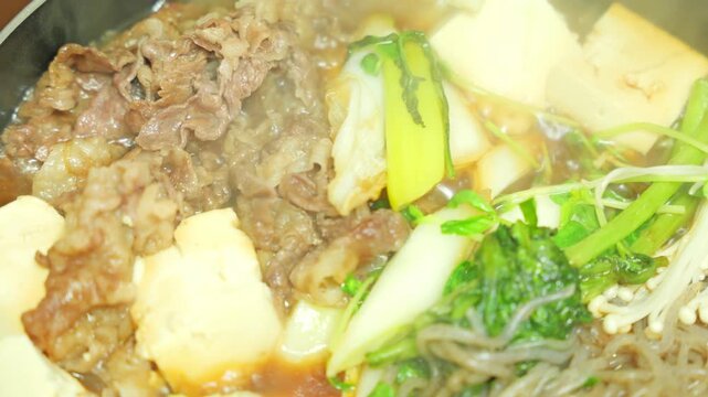 Steaming Hot Sukiyaki with Beef and Vegetables, Traditional Japanese Hot Pot Cuisine