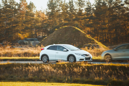 White city car traveling near construction area