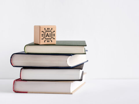 Wooden block with AI circuit symbol on stack of books