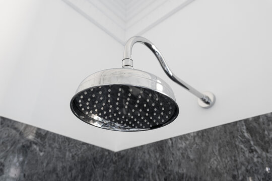 Close up of a Retro style chrome rain shower head in luxury bathroom