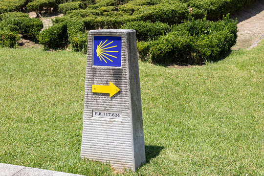 camino de santiago portuguese way stone milestone marker with scallop shell and yellow arrow
