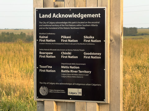 Calgary, Alberta, Canada. August 24, 2026. Straight-on close-up of an official Indigenous Land Acknowledgement sign posted in a local park.