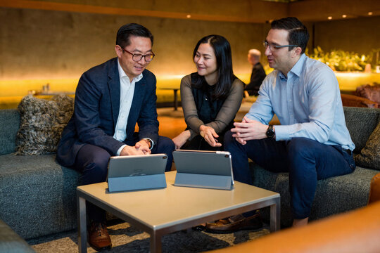 Colleagues Discussing AI Governance in a Modern Lounge