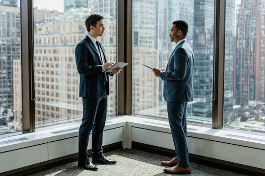 Two Executives Discussing Strategy in a Modern Corner Office