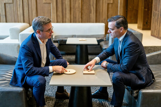 Corporate Executives Negotiating Strategy in a Modern Lounge