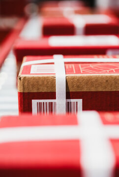 Cardboard shipping boxes with barcodes on a conveyor belt