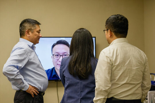 Business Professionals Discussing AI Ethics via Video Conference