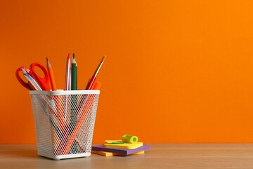 Pencil holder with school supplies on wooden table. Back to school concept © Sunlight