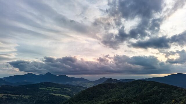 Aerial Forward Hyperlapse of Dramatic Sunset Sky Over Forested Mountain Range