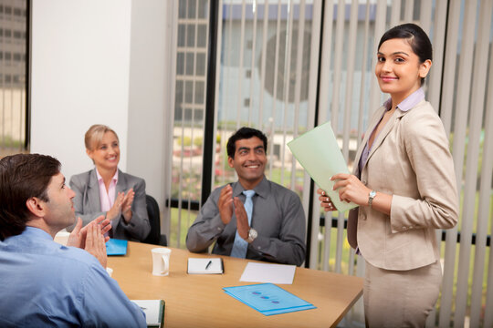Female executive getting an applause