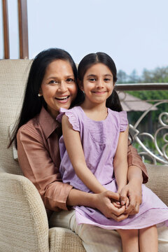 Girl sitting on her grandmothers lap