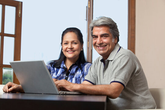 Portrait of an old couple with a laptop