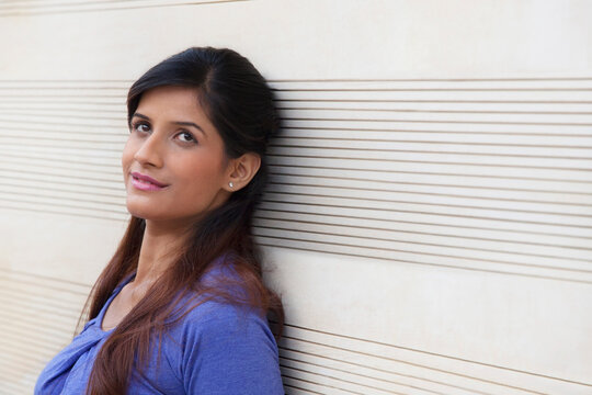 Woman leaning against a wall