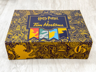 Naklejka premium Toronto, Ontario, Canada. August 12, 2026. Angled close-up of a limited-edition Harry Potter x Tim Hortons donut box on a light surface.