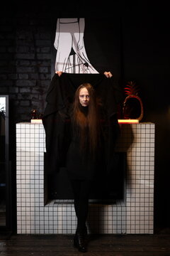 Opulent costume featuring intricate textures and striking silhouette