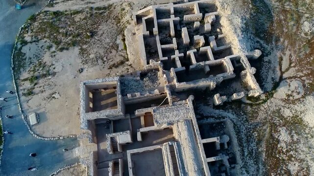Detailed aerial daytime shot of Kish Island modern buildings and coastal development with clear turquoise sea.
