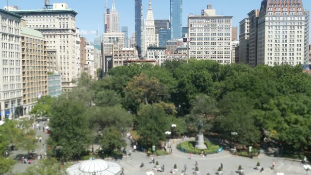 New York City Manhattan Midtown Union Square on Broadway street, United States of America. Old historic building urban architecture from above. Cityscape skyline and summer greenery in park. People.