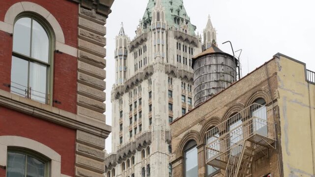 New York City Woolworth building 1913, skyscraper on Broadway, Downtown Financial District, Lower Manhattan, United States of America. Gothic historic architecture, green cooper roof, ater tower tank.