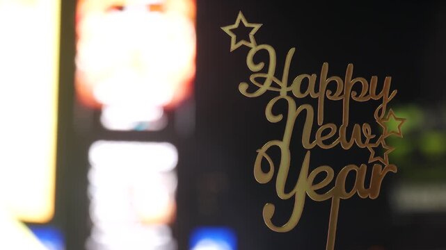 Happy New Year text sign on Times Square in New York City, United States. Illuminated screens during Christmas holidays in December on Manhattan. Festive celebration on Broadway in USA. Glowing lights